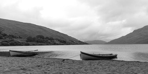 A pair of boats on the sand in the rain at Lough Nafooey in County Galway. Looking towards the Mayo border. Lough Nafooey is a rectangular shaped glacial lake on the border of County Mayo and County Galway.