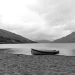 A boat on the sand in the rain at Lough Nafooey in County Galway. Looking towards the Mayo border. Lough Nafooey is a rectangular shaped glacial lake on the border of County Mayo and County Galway.