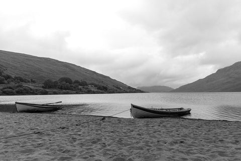 A pair of boats on the sand in the rain at Lough Nafooey in County Galway. Looking towards the Mayo border.