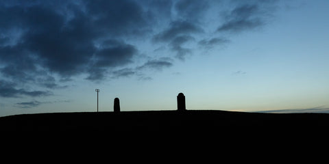 The Lia Fáil and the memorial headstone on the Hill of Tara at sunrise.