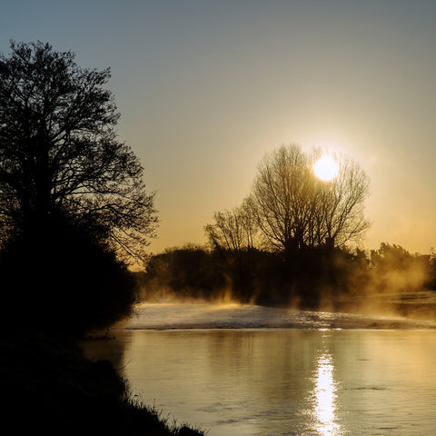 The sun rises over the foggy River Boyne at Trim. 