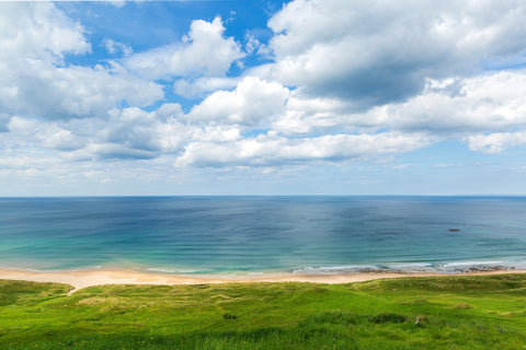 A breathtaking view of White Park Bay in Antrim with a cloudy sky.